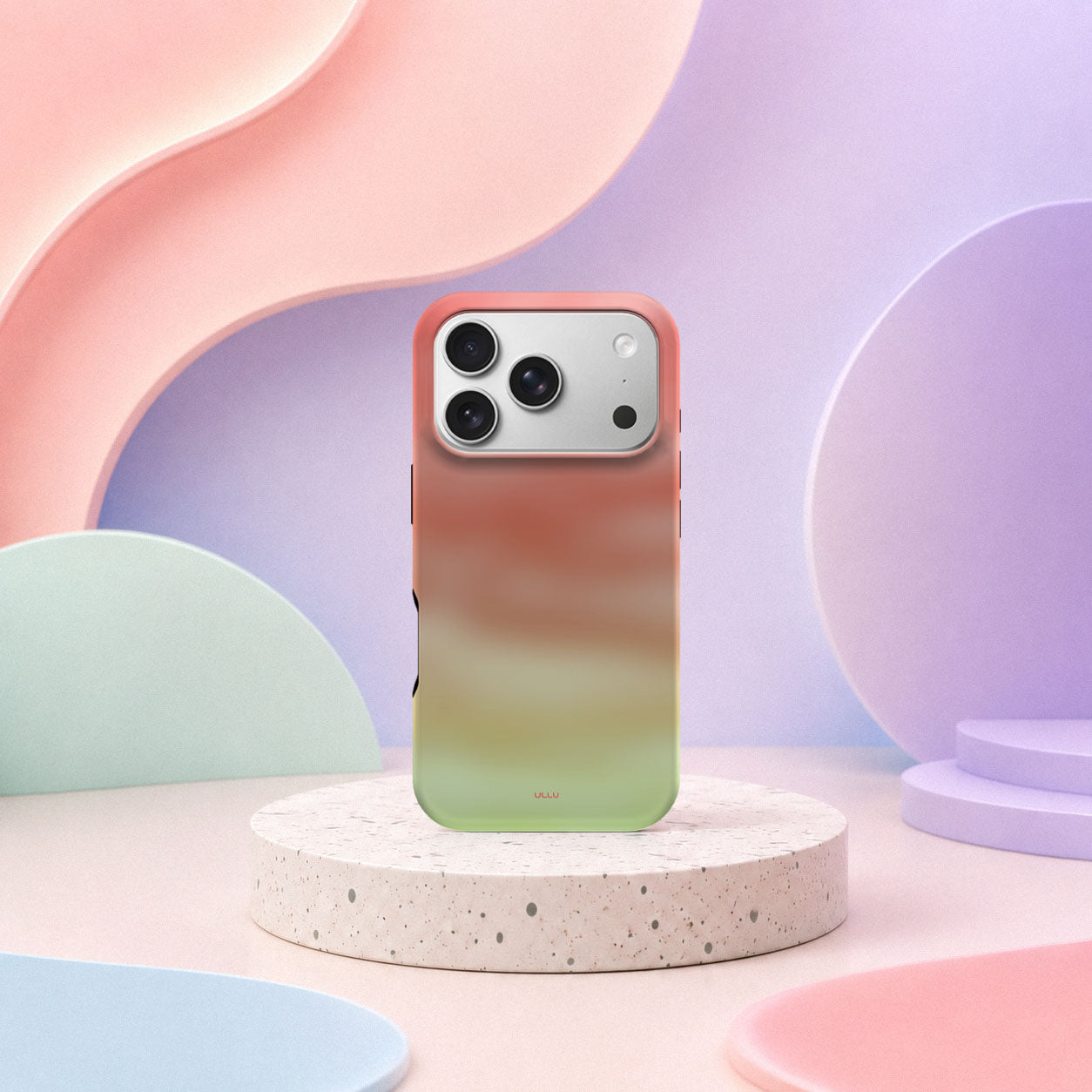 iPhone 17 Pro deksel Koralldis med korallrosa, beige og grønn gradient i mykt pastellinteriør